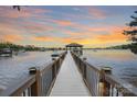 Sunset view of a private pier with a covered gazebo on the lake at 17112 Green Dolphin Ln, Cornelius, NC 28031