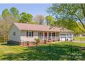 Well-kept home with a welcoming front porch, verdant lawn, and easy driveway access at 174 Stewart Acres Dr, Statesville, NC 28677