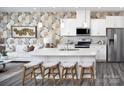 Modern kitchen features white cabinets, stainless steel appliances, and a large island with bar seating at 2425 Hedgecliff Rd, Kannapolis, NC 28025