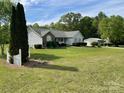Charming home boasts a spacious yard, well-kept landscaping, and white picket fence, perfect curb appeal at 260 Treebark Rd, Statesville, NC 28625
