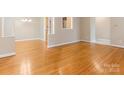 Bright, open living room featuring gleaming hardwood floors and neutral paint at 3615 Champaign St, Charlotte, NC 28210