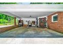 Covered carport with brick accents, offering ample storage space, and convenient access to the home's side entrance at 3810 Springway Dr, Gastonia, NC 28056