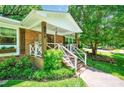 Inviting front porch with brick steps, white railings, and decorative touches add to the home's curb appeal at 3810 Springway Dr, Gastonia, NC 28056