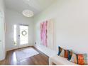 Bright entryway features wood floors, a modern light fixture, and stylish decor at 4211 Mantle Ct, Charlotte, NC 28205