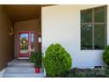 Charming entrance with a red door, decorative wreath, and modern lighting fixtures at 4211 Mantle Ct, Charlotte, NC 28205
