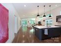 Open living space with hardwood floors, modern lighting, and a seamless flow at 4211 Mantle Ct, Charlotte, NC 28205