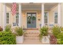 Close up view of the front door and porch, with rocking chairs and decorations at 5250 Meadowcroft Way, Fort Mill, SC 29708