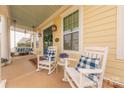 Cozy front porch with rocking chairs, swing, and charming decor elements at 5250 Meadowcroft Way, Fort Mill, SC 29708