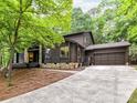 Charming home with a stone facade and a well-maintained lawn, complemented by a paved driveway at 6017 Lake Providence Ln, Charlotte, NC 28277