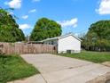 Spacious backyard featuring a paved driveway and wooden fence, offering privacy and space for outdoor activities at 620 Third St, Rock Hill, SC 29730