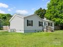 Exterior side view showcasing the home's well-kept lawn and features a classic window shutters at 620 Third St, Rock Hill, SC 29730