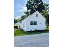 Exterior view of a home showcasing a neatly landscaped yard with a gravel driveway at 716 E Union St, Marshville, NC 28103