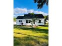 Quaint home featuring a lush green lawn, traditional design, and inviting curb appeal at 716 E Union St, Marshville, NC 28103