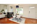Cozy dining room with fireplace, and a large window to let in sunlight at 8233 Christmas Ct, Charlotte, NC 28216