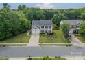 An aerial view of a lovely home with mature trees and lush landscaping on a quiet street at 8707 Darcy Hopkins Dr, Charlotte, NC 28277