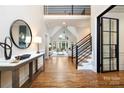 Welcoming foyer featuring hardwood floors, a staircase, and an open view to the living room at 9013 Yellow Pine Ct, Waxhaw, NC 28173