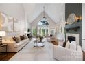 Spacious living room with vaulted ceilings, large windows, elegant furnishings, and a fireplace at 9013 Yellow Pine Ct, Waxhaw, NC 28173