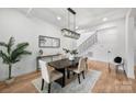 Elegant dining room featuring modern chandelier, console table with decor, and open access to the staircase at 910 Everett Pl, Charlotte, NC 28205