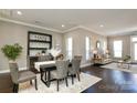 Open-concept dining room with bar area, dark wood floors and natural light at 926 Steel House Blvd, Charlotte, NC 28205