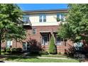 Brick townhome exterior featuring multiple windows, balconies, covered entrances, and lush landscaping at 926 Steel House Blvd, Charlotte, NC 28205