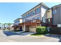 Modern townhome showcases a private deck and attached garage, enhancing curb appeal at 926 Steel House Blvd, Charlotte, NC 28205