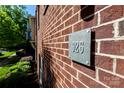 The house number 926 on a red brick building is displayed on a green sign with silver numbers at 926 Steel House Blvd, Charlotte, NC 28205