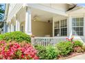 Cozy front porch with seating, beautiful landscaping, and a welcoming entrance at 1027 Feather Oak Ln, Matthews, NC 28104