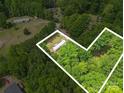 An aerial view of the home reveals its setting amidst a canopy of green trees, enhancing its privacy at 10420 Silver Mine Rd, Indian Land, SC 29707