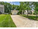 View of the driveway of a single-story home with an attached garage and manicured lawn at 11224 Amber Glen Dr, Charlotte, NC 28269