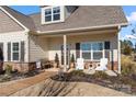 Inviting front porch with stylish seating and meticulous landscaping, adding to the home's curb appeal at 11249 Island View Ln, Lancaster, SC 29720