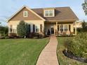 Charming single Gathering home with a well maintained lawn and walkway leading to the front porch at 11249 Island View Ln, Lancaster, SC 29720