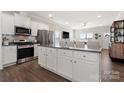 Modern kitchen featuring white cabinets, stainless steel appliances, granite counters, and a large center island at 11249 Island View Ln, Lancaster, SC 29720
