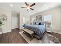 Spacious main bedroom with a ceiling fan, wood-look floors, neutral paint, and a sitting nook at 11249 Island View Ln, Lancaster, SC 29720