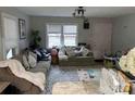 Cozy living room with large windows, neutral tones, and comfortable seating at 1203 Pamela Dr, Shelby, NC 28150