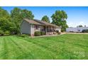 A lovely home with a verdant lawn, attractive landscaping, and a side-entry garage at 130 Helen Dr, Statesville, NC 28625