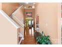 Bright foyer with hardwood floors, a high ceiling, and a staircase leading to the upper level at 13502 Brandon Trail Dr, Charlotte, NC 28213