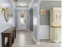 Inviting foyer with hardwood flooring, decorative mirror, and neutral paint, creating a warm welcome at 137 Sugar Magnolia Dr, Mooresville, NC 28115