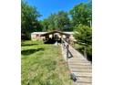 Inviting home featuring covered parking and a wooden walkway at 143 Greenville Blvd, Bessemer City, NC 28016
