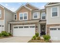 Charming home featuring a two-car garage, stone accents, and a mix of vinyl and shingle siding at 15622 Little Bluestem St, Charlotte, NC 28278