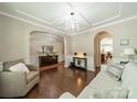 Elegant living room featuring hardwood floors, stylish furnishings, and a decorative chandelier at 16507 Palisades Commons Dr, Charlotte, NC 28278
