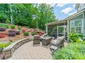 Beautiful outdoor patio area with comfortable seating and a lush, landscaped backyard at 16507 Palisades Commons Dr, Charlotte, NC 28278