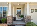 Inviting front porch with stone accents and elegant details, offering a warm welcome at 199 Blossom Ridge Dr, Mooresville, NC 28117