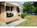 Inviting front porch with stylish outdoor seating and a view of the landscaped yard at 200 Elizabeth Ave # 1, Monroe, NC 28112