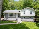 Charming two-story home featuring updated paint, black trim, and a well-manicured front lawn at 2009 Edgewater Dr, Charlotte, NC 28210