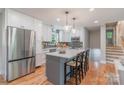 Modern kitchen with white cabinets, stainless steel appliances, and a gray kitchen island at 2009 Edgewater Dr, Charlotte, NC 28210