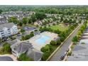 Aerial view of a community featuring a sparkling pool, playground, parking, and lush green spaces for outdoor enjoyment at 2151 Belle Vernon Ave, Charlotte, NC 28210