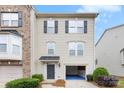 Two-story home features a one-car garage, neutral siding, black shutters, and a covered front entry, combining style and functionality at 2151 Belle Vernon Ave, Charlotte, NC 28210