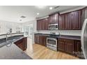 Modern kitchen with stainless steel appliances, dark cabinets, and hardwood flooring at 2151 Belle Vernon Ave, Charlotte, NC 28210