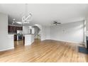 Open-concept living area with hardwood floors, fireplace, and a view into the kitchen at 2151 Belle Vernon Ave, Charlotte, NC 28210
