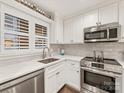 Modern kitchen features white cabinets, stainless steel appliances, and a bright window at 2719 Selwyn Ave # 20, Charlotte, NC 28209
